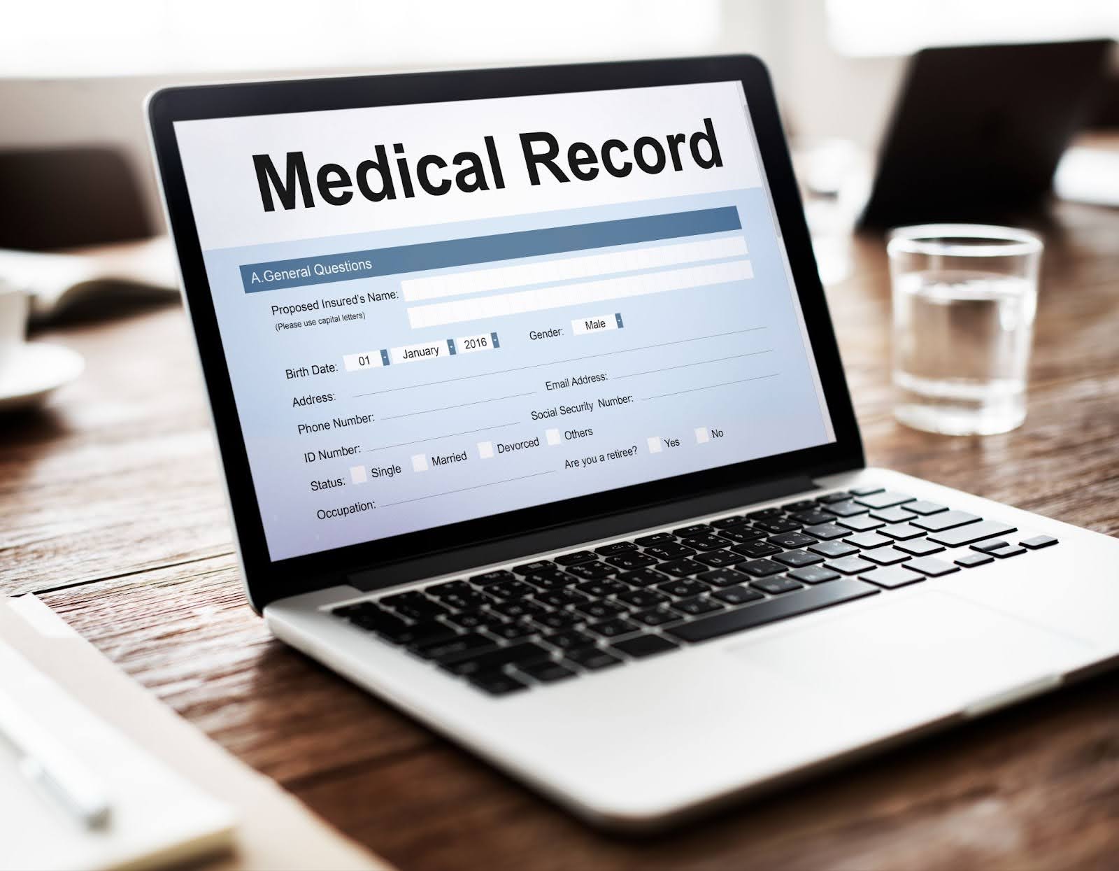 Laptop displaying an electronic medical record (EMR) form on screen, representing the use of electronic health records (EHR) in medical billing.