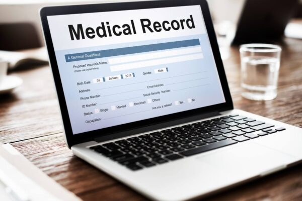 Laptop displaying an electronic medical record (EMR) form on screen, representing the use of electronic health records (EHR) in medical billing.